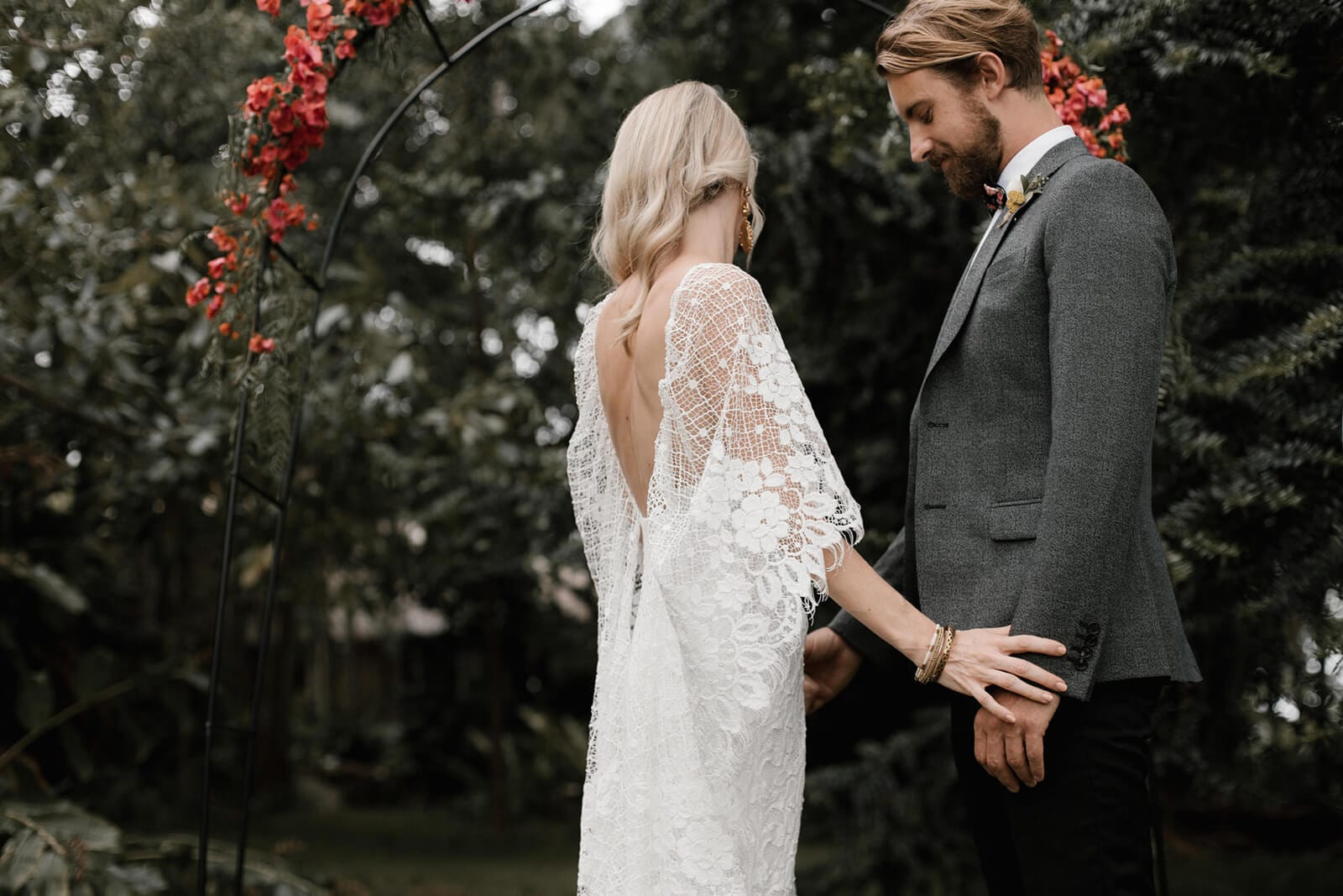 Bride wearing Grace Loves Lace Verdelle 2.0 Gown holding hands with groom