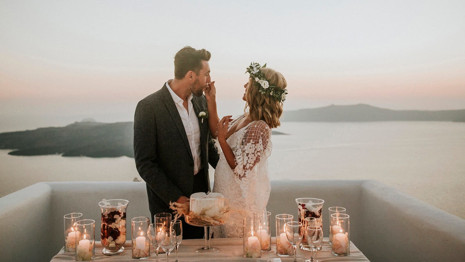 Bride wearing Grace Loves Lace Verdelle 2.0 Gown feeding groom cake
