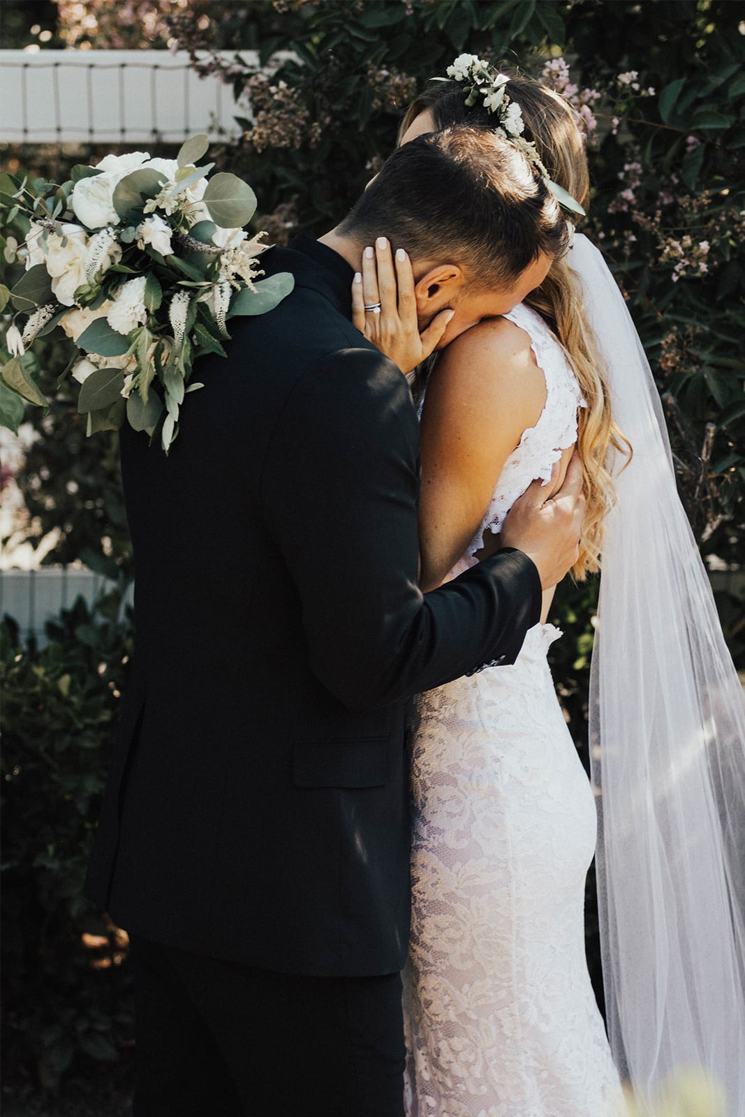 Bride wearing Grace Loves Lace Alexandra Gown with groom leaning on shoulder