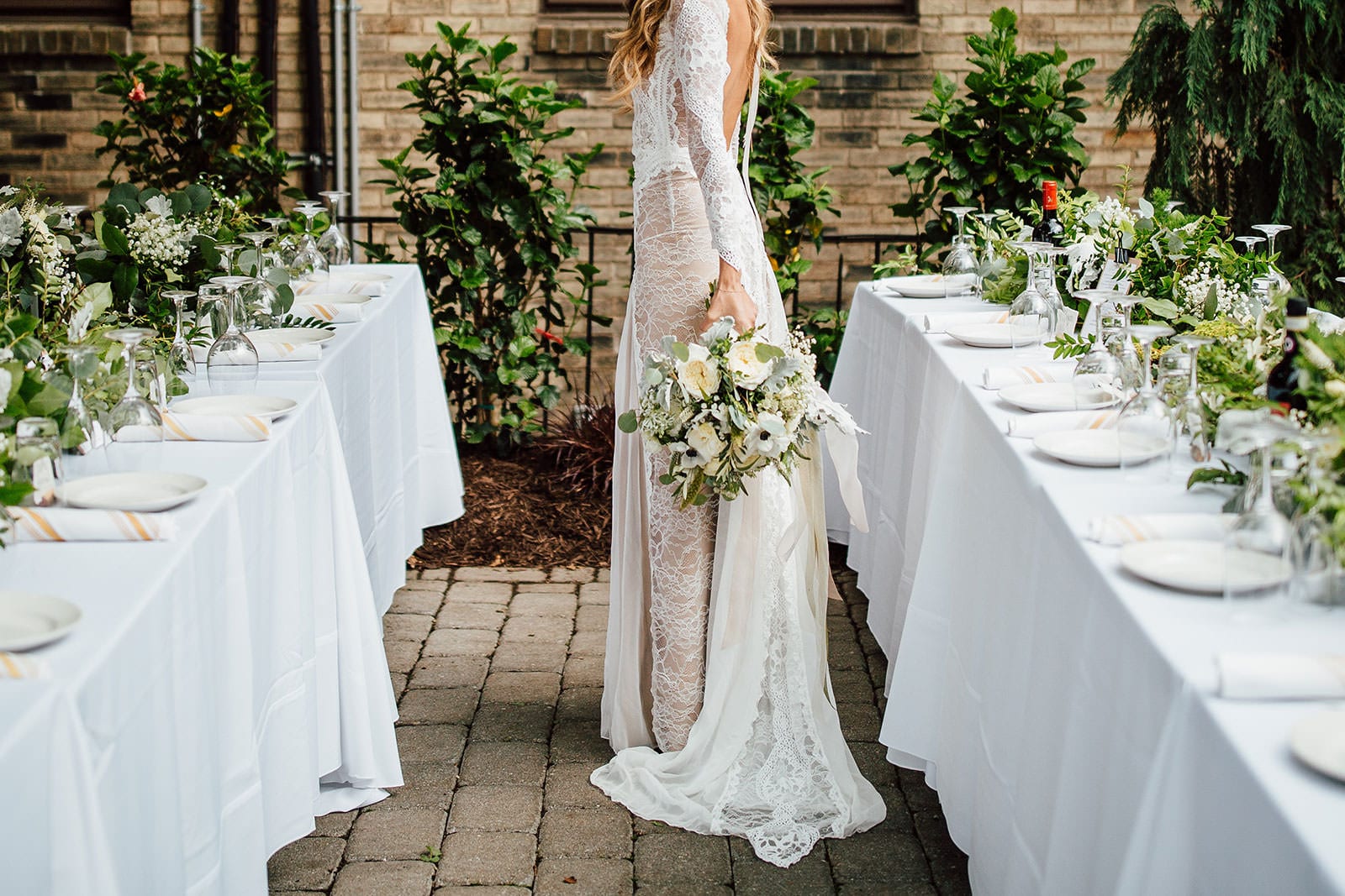 Bride wearing Grace Loves Lace Inca Gown holding bouquet